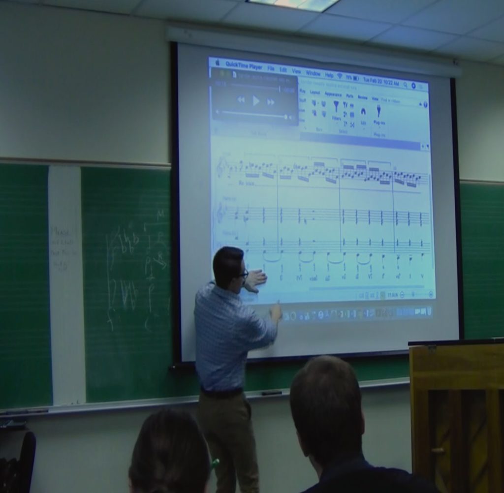 sam reenan teaching in front of the class